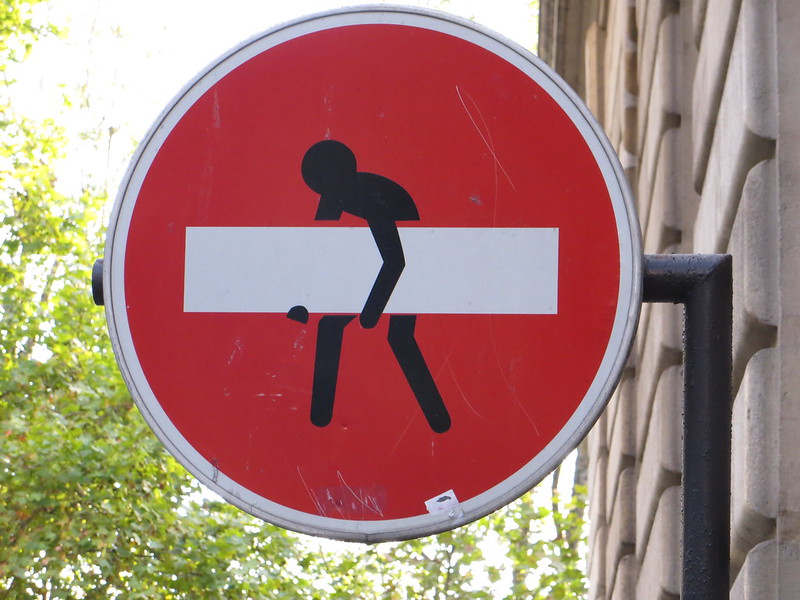 No Entry sign with figure removing central bar
